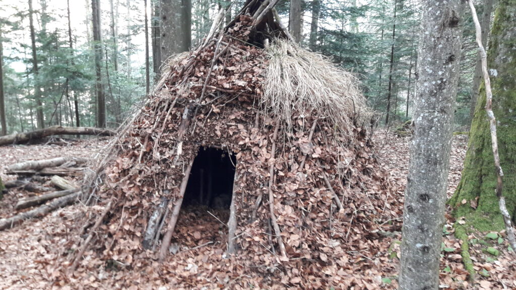 Feuerhof mit Laub, Gras und Ästen als Dämmung